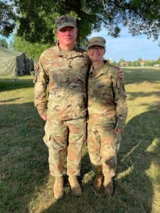 Young woman cadet in army fatigues with her sergeant.