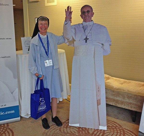 Nun with cardboard cutout of pope.