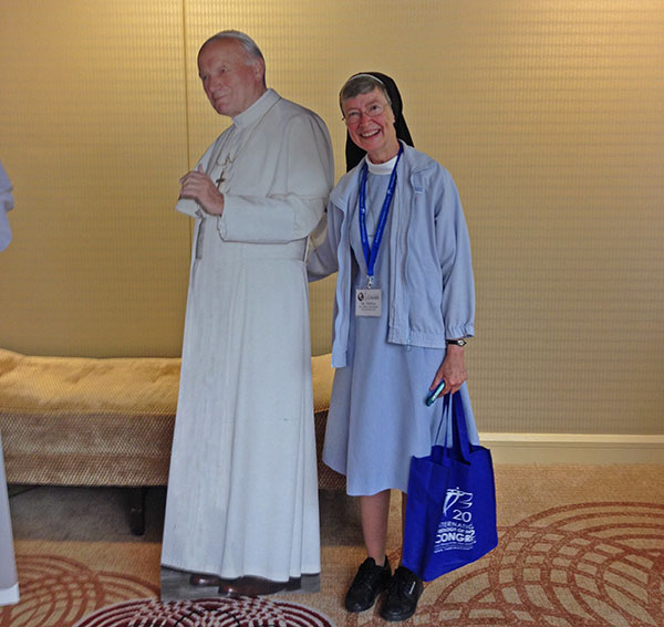 Nun with cutout of pope.