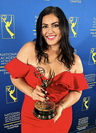 Woman holding Emmy awards