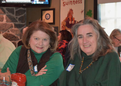 Two women wearing green