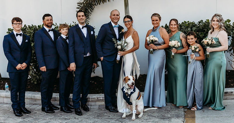 A wedding party with bride, groom, groomsmen and maids of honor