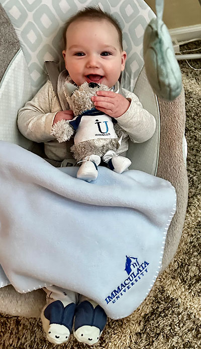 Infant holding stuffed animal