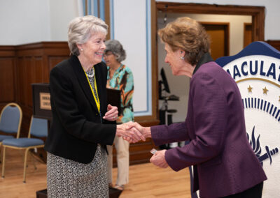 Two women shaking hands