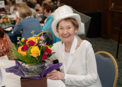 Woman siting at table with flowers