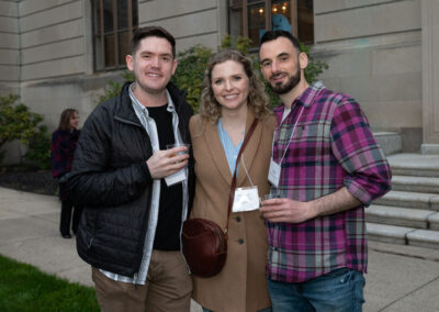 Three people in front of building