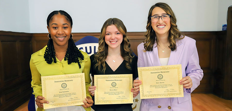 Three women holding certificates