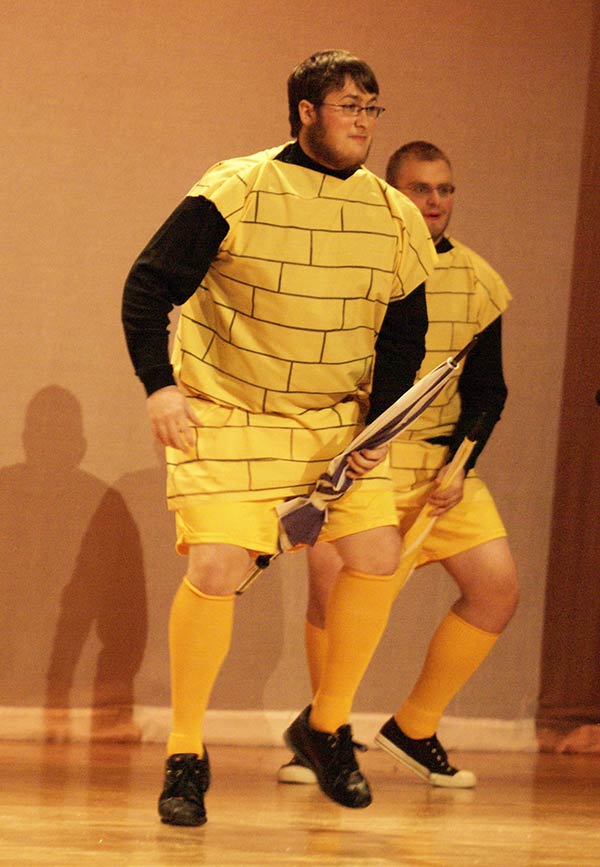 Two men in costumes dancing on stage