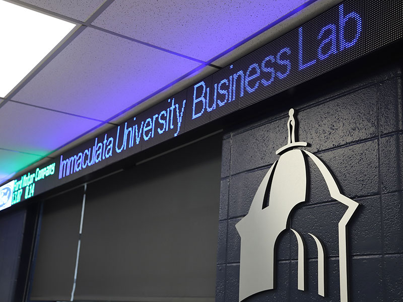 Stock ticker on wall in classroom