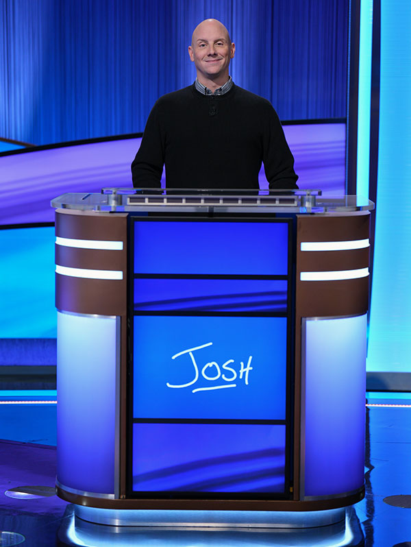 Man standing at podium for Jeopardy TV game show