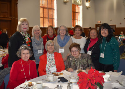 Group of women around a table decorated for Christmas