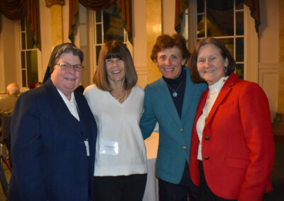 One nun and three other women at event